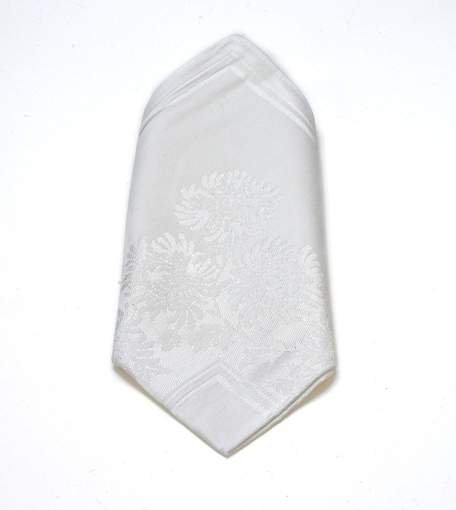 White dinner napkin with Contessa floral design.